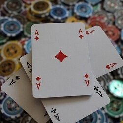Four aces on a pile of poker chips.