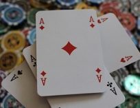 Four aces on a pile of poker chips.
