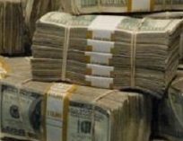 Bundles of $100 bills worth $10,000 stacked on top of each other.