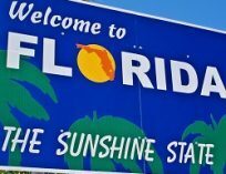 A sign welcoming visitors to Florida, the Sunshine State.
