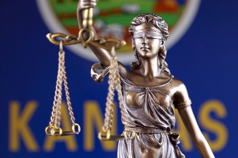 Symbol of law and justice with Kansas State Flag. Close up.