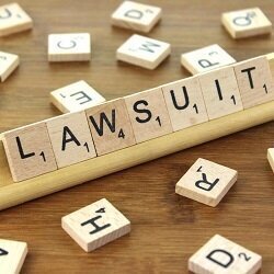 The word "Lawsuit" spelled out in scrabble letters.