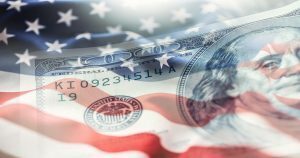 American Flag with ripples as if blowing in the wind with a watermark of an American $100 banknote.