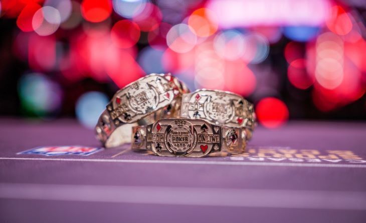 3 WSOP Bracelets on a poker table