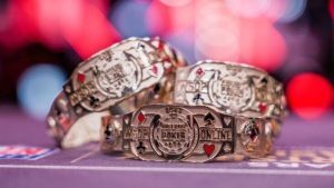 3 WSOP Bracelets on top of poker felt