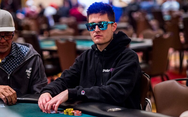 Jeremy Becker with sunglasses on playing poker