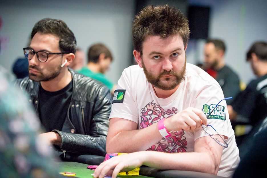 David Lappin playing poker and pointing to his shirt