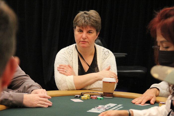 Victoria Livschitz with a coffee at a poker table
