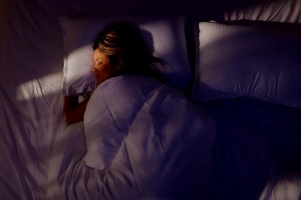 a girl sleeping in the dark
