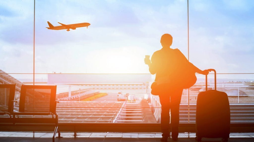someone staring out to a plane who is about to travel
