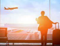 someone staring out to a plane who is about to travel