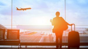 someone staring out to a plane who is about to travel