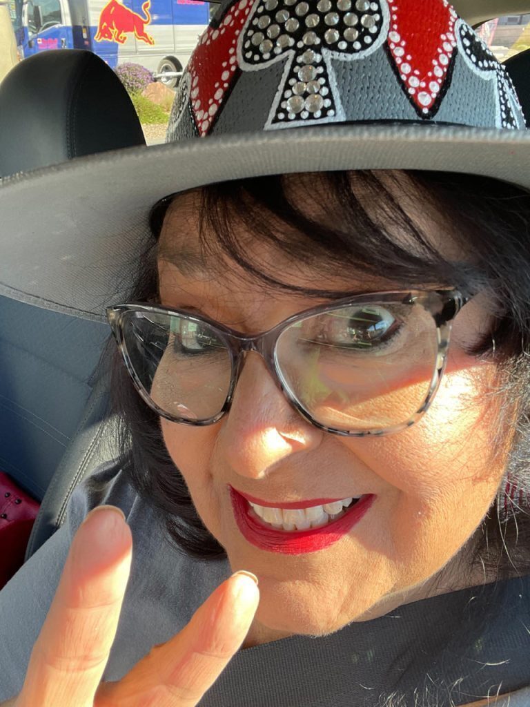 Lupe Soto take a selfie with a peace sign up