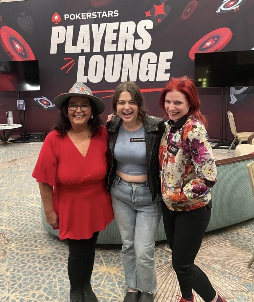 Lupe Soto taking a photo with 2 fans