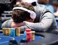 Poker Player with Head on Table Angry after Bad Beat