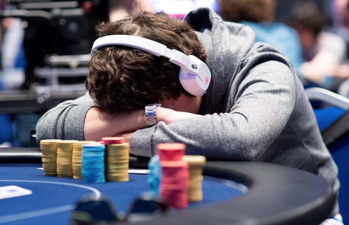 Poker Player with Head on Table Angry after Bad Beat