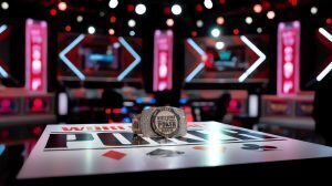 World Series of Poker bracelet on a branded poker table, with a blurred WSOP final table stage in the background.