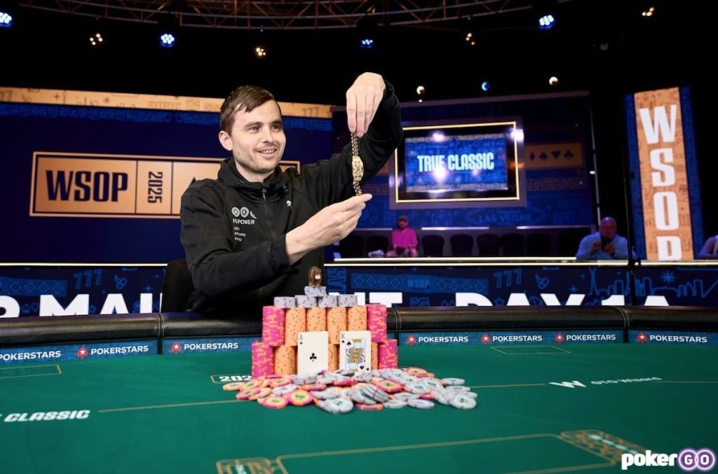 Martin Kabrhel holding up bracelet in front of chips