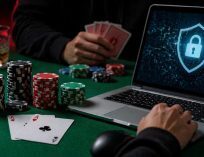 Online poker game on a laptop with security lock icon, poker chips, and playing cards on a table