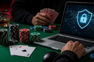 Online poker game on a laptop with security lock icon, poker chips, and playing cards on a table