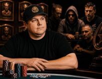 Poker player sitting at a table surrounded by championship bracelets and chips with a hall of fame backdrop in a dramatic casino setting.