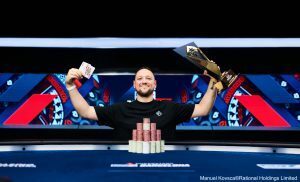 Manuel Ferrari celebrates winning the 2026 EPT Barcelona Main Event with his trophy and winning hand.