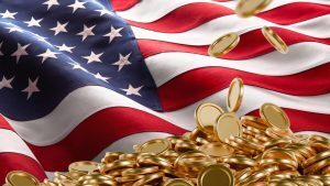 Gold coins falling onto a pile against a waving American flag.